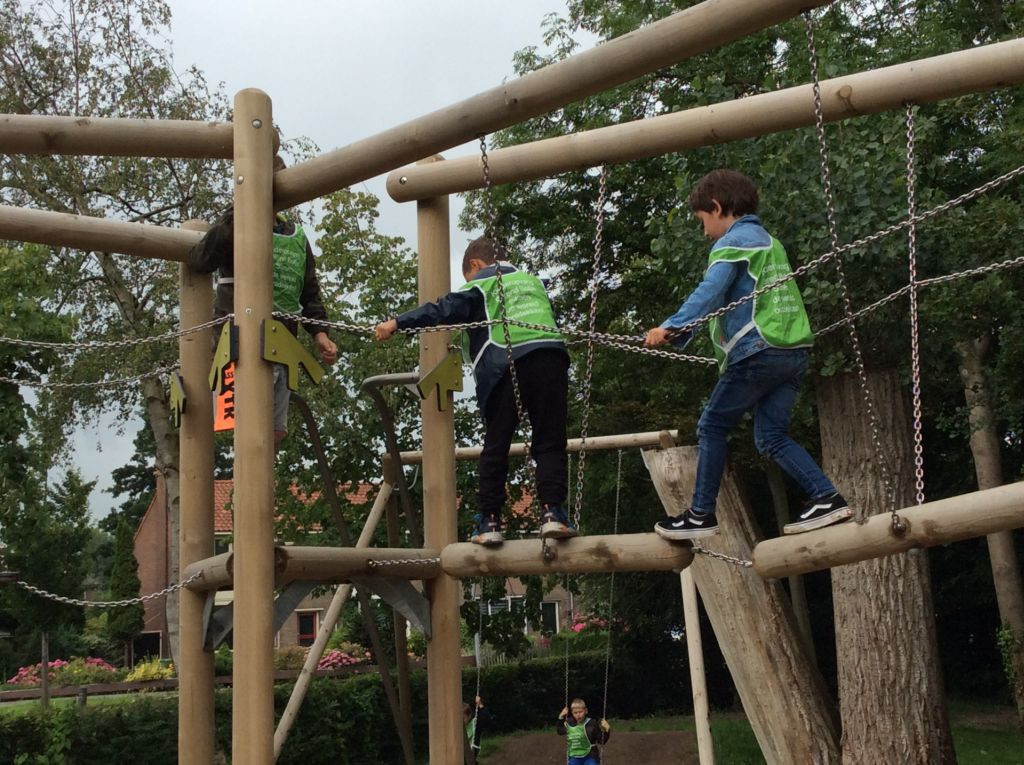 kinderen klimmen op speeltoestel