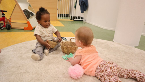 twee kinderen spelen samen op het kleed
