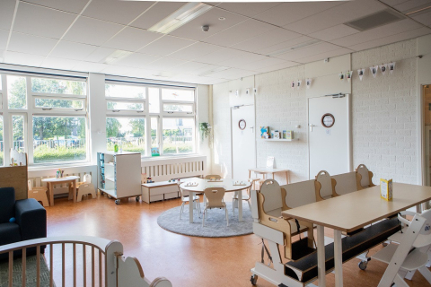 groepsruimte van babygroep met tafels en speelhoeken