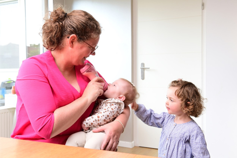 Gastouder geeft baby de fles
