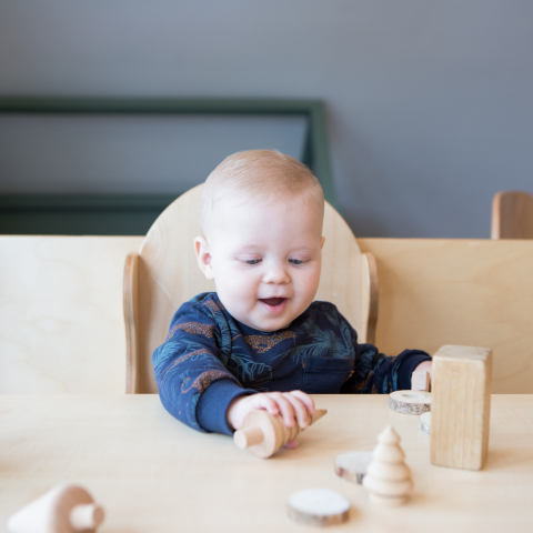 baby speelt met houten blokken